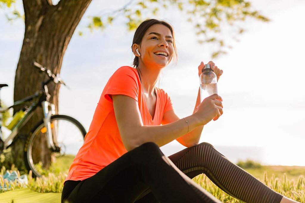 _smiling-beautiful-woman-drinking-water-bottle-doing-sports-morning-park