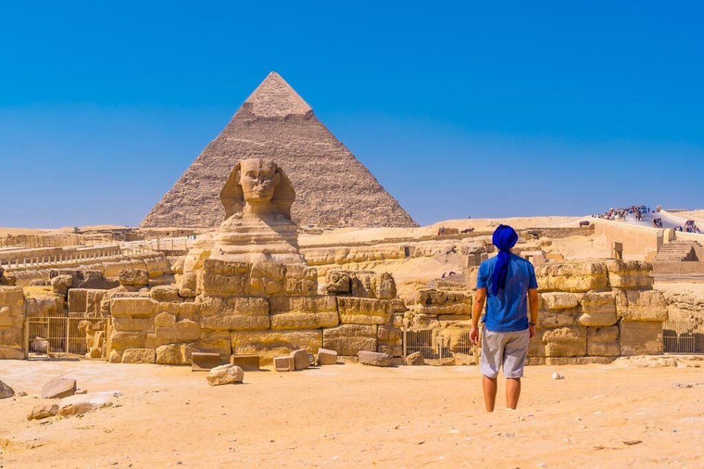 _young-man-walking-towards-great-sphinx-giza