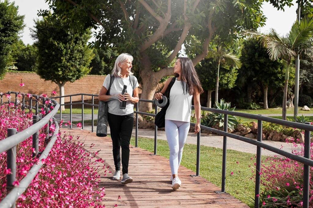 _age-difference-female-friends-meeting-up-yoga-outdoors