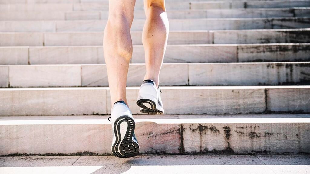 _crop-legs-sneakers-running-upstairs